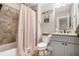 Well-lit bathroom with tiled shower-tub combo, granite countertop, and modern fixtures at 764 Little Vine Church Rd, Villa Rica, GA 30180