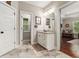 Bright bathroom featuring granite counters, vanity with cabinet storage, and tile flooring at 764 Little Vine Church Rd, Villa Rica, GA 30180