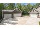 Spacious detached three-car garage with concrete driveway, and secure fenced area at 764 Little Vine Church Rd, Villa Rica, GA 30180