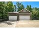 Detached three-car garage featuring ample parking space and a fenced enclosure at 764 Little Vine Church Rd, Villa Rica, GA 30180
