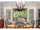 Dining area with chandelier views screened-in porch with lots of natural light at 764 Little Vine Church Rd, Villa Rica, GA 30180