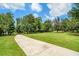 Long concrete driveway leading to the property, surrounded by lush trees at 764 Little Vine Church Rd, Villa Rica, GA 30180