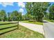 Long driveway entrance with wooden fence, leading to a private home at 764 Little Vine Church Rd, Villa Rica, GA 30180