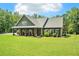 Charming single-Gathering home with covered front porch, manicured lawn, and attractive landscaping at 764 Little Vine Church Rd, Villa Rica, GA 30180