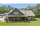 Attractive home with covered porch, stone accents, and a well-maintained lawn with mature trees at 764 Little Vine Church Rd, Villa Rica, GA 30180