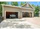 Large garage with two bays featuring a lift, storage, and ample space for vehicles and projects at 764 Little Vine Church Rd, Villa Rica, GA 30180