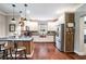 Well-lit kitchen with white cabinets, stainless steel appliances, hardwood floors, and a center island at 764 Little Vine Church Rd, Villa Rica, GA 30180