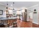 Well-lit kitchen features stainless appliances, wood accents, island seating and hardwood floors at 764 Little Vine Church Rd, Villa Rica, GA 30180