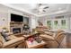 Living room has a stone fireplace, hardwood floors and ample natural light at 764 Little Vine Church Rd, Villa Rica, GA 30180