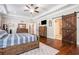 Comfortable main bedroom featuring stylish furniture, hardwood floors, and sliding barn door at 764 Little Vine Church Rd, Villa Rica, GA 30180
