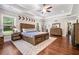 Bright main bedroom with hardwood floors, ceiling fan, and large windows offering scenic views at 764 Little Vine Church Rd, Villa Rica, GA 30180