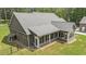 The rear exterior showcases a screened-in porch with multiple windows and a meticulously landscaped yard, offering serene outdoor living at 764 Little Vine Church Rd, Villa Rica, GA 30180