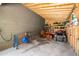 Functional storage area with shelves, tools, and equipment for lawn and garden maintenance at 764 Little Vine Church Rd, Villa Rica, GA 30180