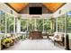 Bright sunroom with multiple windows, comfortable seating, and nature views at 764 Little Vine Church Rd, Villa Rica, GA 30180