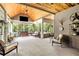 Screened-in porch offering relaxed seating and views of a wooded backyard at 764 Little Vine Church Rd, Villa Rica, GA 30180