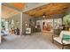 Spacious sunroom with wood ceiling, casual seating, and access to dining area at 764 Little Vine Church Rd, Villa Rica, GA 30180