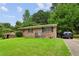 Brick ranch house with a spacious yard and driveway at 792 Plainville Sw Cir, Atlanta, GA 30331