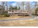 Two-story brick home with a long driveway and mature trees at 1036 Wooten Lake Nw Rd, Kennesaw, GA 30144