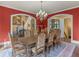 Formal dining room with elegant chandelier, trim and view of the entry staircase at 2554 Emerald Dr, Jonesboro, GA 30236