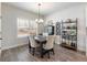 Bright dining room with hardwood floors and a farmhouse table at 1018 Cherry Bark Ln, Loganville, GA 30096