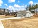 House exterior showcasing a three-car garage and landscaping at 1018 Cherry Bark Ln, Loganville, GA 30096