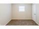 Bedroom featuring neutral walls, brown carpet, and a window at 5925 S Quail Dr, Douglasville, GA 30135