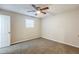 Cozy bedroom featuring plush carpet, a ceiling fan, and natural light at 5925 S Quail Dr, Douglasville, GA 30135