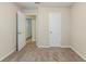 Bedroom featuring neutral walls, brown carpet, and doors leading to other rooms at 5925 S Quail Dr, Douglasville, GA 30135