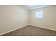 Bedroom featuring neutral walls, brown carpet, and a window at 5925 S Quail Dr, Douglasville, GA 30135