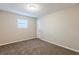 Bedroom featuring neutral walls, brown carpet, and a window at 5925 S Quail Dr, Douglasville, GA 30135
