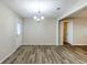 Open dining area with modern flooring, a stylish chandelier, and easy access to the backyard at 5925 S Quail Dr, Douglasville, GA 30135
