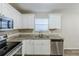 Well-lit kitchen with stainless steel appliances, granite countertops, and ample cabinet space at 5925 S Quail Dr, Douglasville, GA 30135