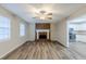 Spacious living room with a brick fireplace, modern flooring, and lots of natural light at 5925 S Quail Dr, Douglasville, GA 30135