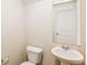 Bathroom featuring modern fixtures including a pedestal sink and toilet at 148 Oliver Dr, Locust Grove, GA 30248