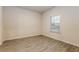 Bedroom with natural light, neutral walls, and updated plank flooring at 148 Oliver Dr, Locust Grove, GA 30248