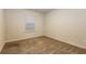 Bedroom featuring neutral walls, carpet flooring, and a window at 148 Oliver Dr, Locust Grove, GA 30248