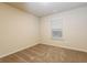 A cozy bedroom featuring neutral walls, carpet flooring, and a window at 148 Oliver Dr, Locust Grove, GA 30248