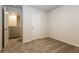 Bedroom with plush carpeting and an open door showcasing the layout at 148 Oliver Dr, Locust Grove, GA 30248
