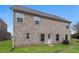 Rear exterior with brick and multiple windows providing ample natural light at 148 Oliver Dr, Locust Grove, GA 30248