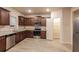 Well-lit kitchen featuring wood cabinets, stainless steel appliances, and a pantry at 148 Oliver Dr, Locust Grove, GA 30248