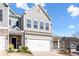 Two-story townhome with gray siding, white garage door, and landscaping at 38 Rocky Knl, Dallas, GA 30157