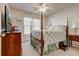 Bedroom with a four-poster bed, ceiling fan, and a window offering natural light at 5712 Overlook Cir, Powder Springs, GA 30127