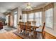 Sunlit dining room with hardwood floors, large windows, and traditional-style furnishings at 5712 Overlook Cir, Powder Springs, GA 30127