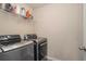 Convenient laundry room with washer, dryer, and shelving at 435 Auburn Crossing Dr, Auburn, GA 30011