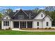 Two-story farmhouse with gray and white exterior, landscaped lawn at 152 Palisade Dr, Rydal, GA 30171