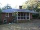 Backyard view showing the home's exterior with a screened porch at 1634 Willis Mill Sw Rd, Atlanta, GA 30311