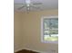 Bright bedroom featuring hardwood floors, natural light, and a ceiling fan at 1634 Willis Mill Sw Rd, Atlanta, GA 30311