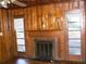 Inviting living room boasts a brick fireplace, wood paneling, and ample natural light at 1634 Willis Mill Sw Rd, Atlanta, GA 30311