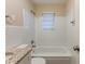Updated bathroom with white tile, bathtub, and granite vanity at 404 Utoy Sw Cir, Atlanta, GA 30331