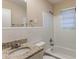 Clean bathroom with granite countertop, white tile, and bathtub at 404 Utoy Sw Cir, Atlanta, GA 30331